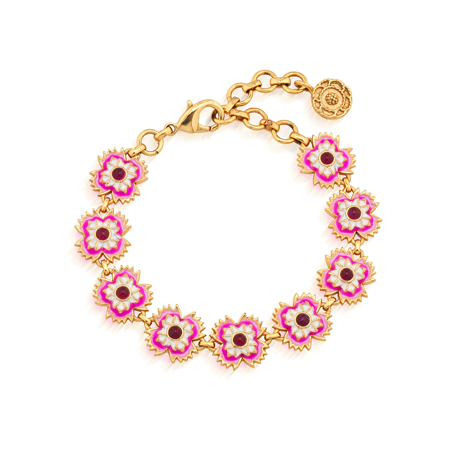 Gold bracelet with pink floral links on a white background