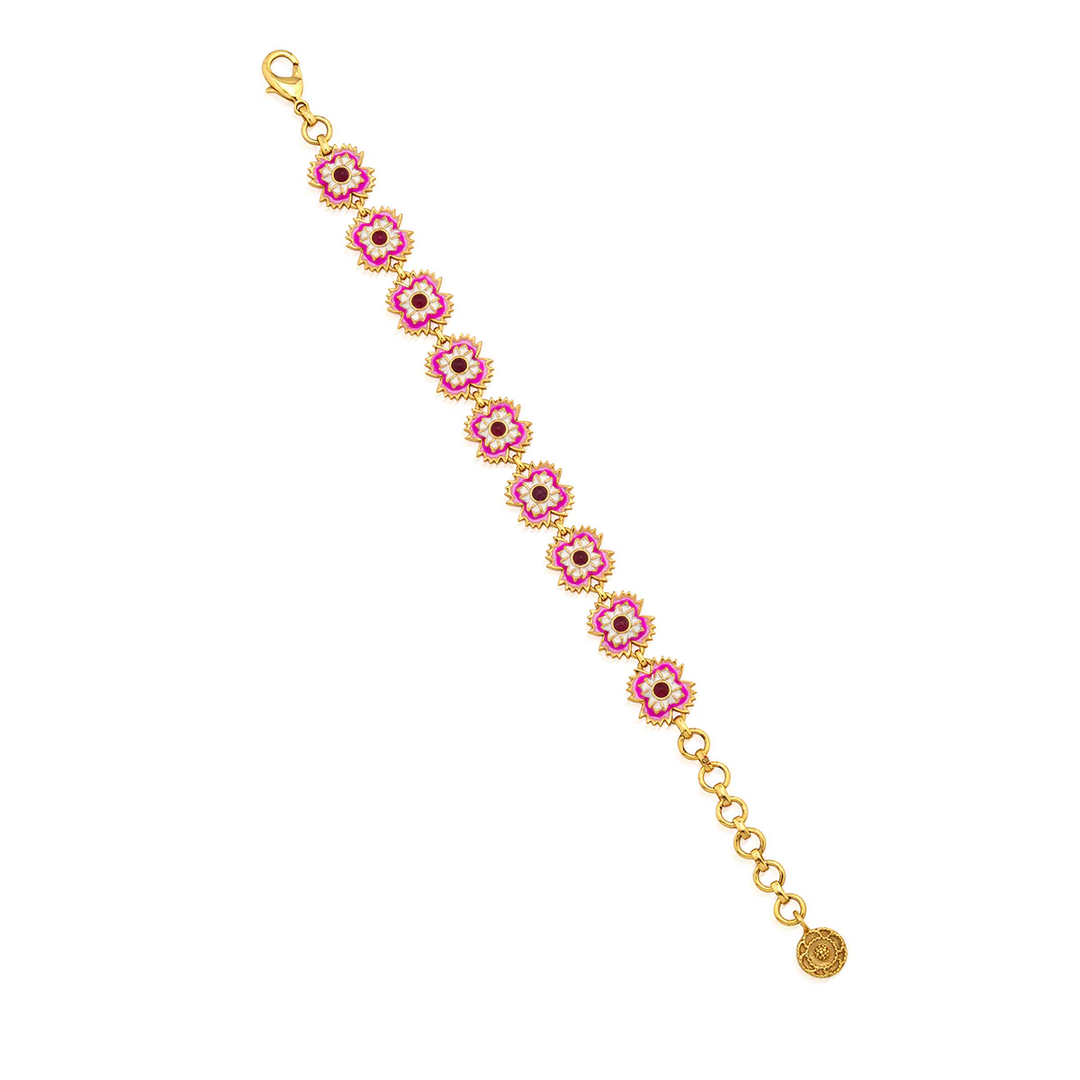 Gold bracelet with pink floral links on a white background