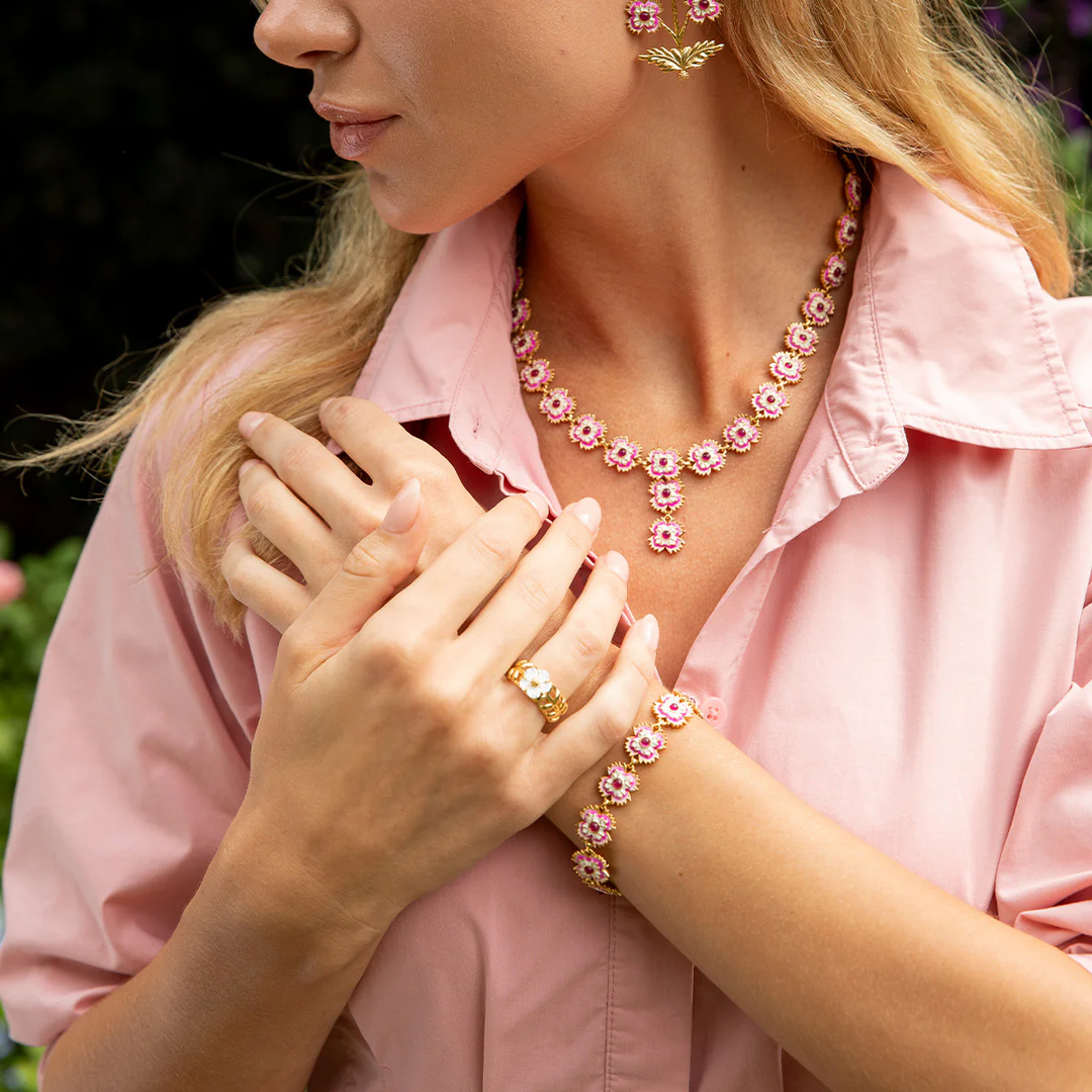 Woman wearing pink floral jewelry set outdoors
