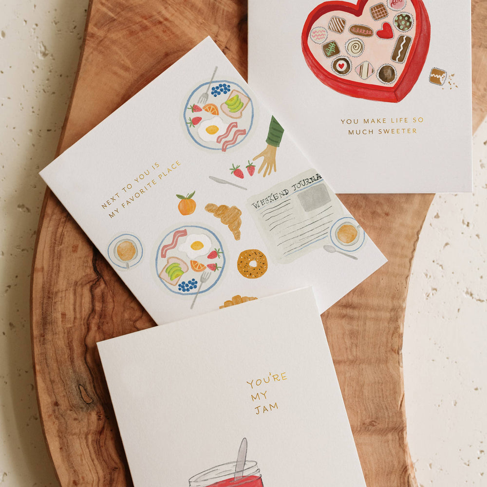 Set of greeting cards with illustrations on a wooden surface
