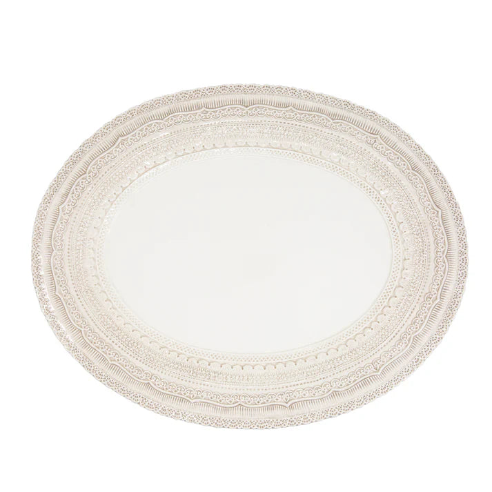 an oval white platter with a lacy rim design against a white background