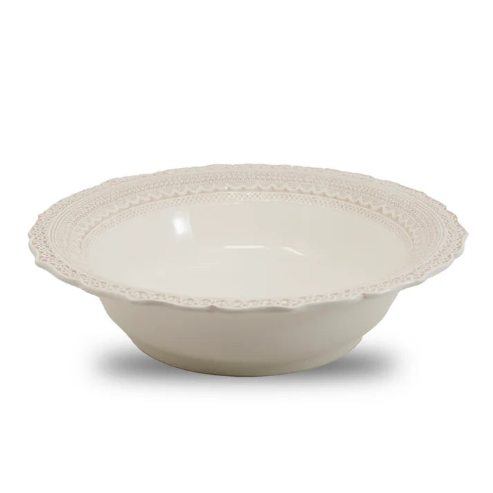 A white ceramic bowl with a lacy rim design 