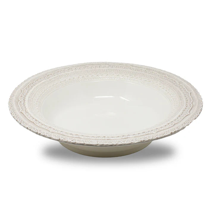 White ceramic bowl with decorative lace styled rim on a white background
