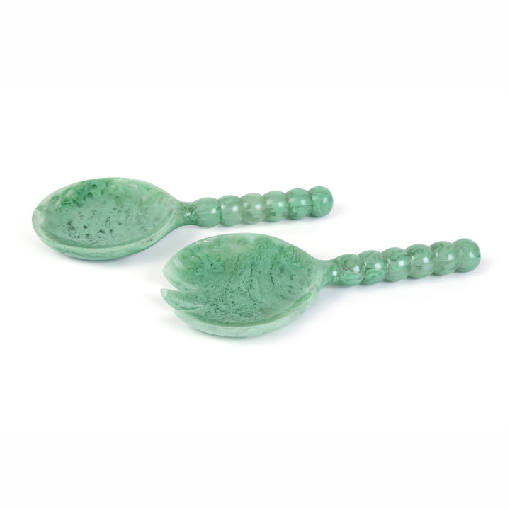 A pair of green stone serving spoons with textured, marbled surfaces and beaded handles, displayed on a clean white background.