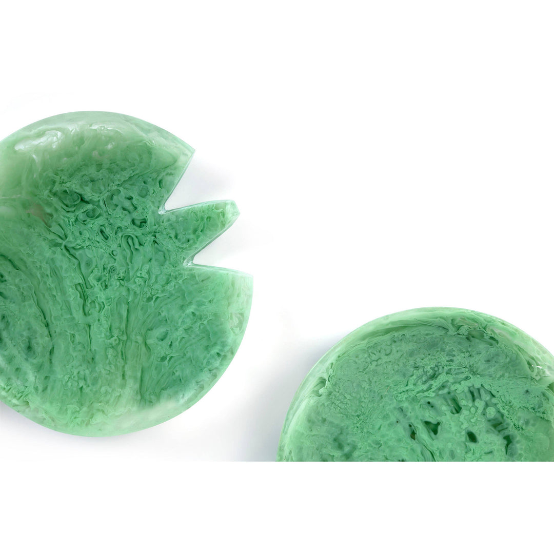 Two green leaf-shaped sponges on a white background