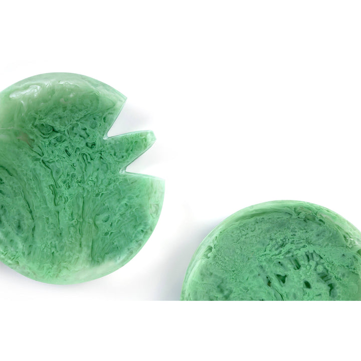 Two green leaf-shaped sponges on a white background