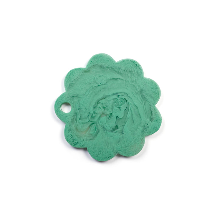A single scalloped oval pendant or charm in a mint green turquoise color, featuring a raised central design and a small loop on the left side, shown on a plain white background.