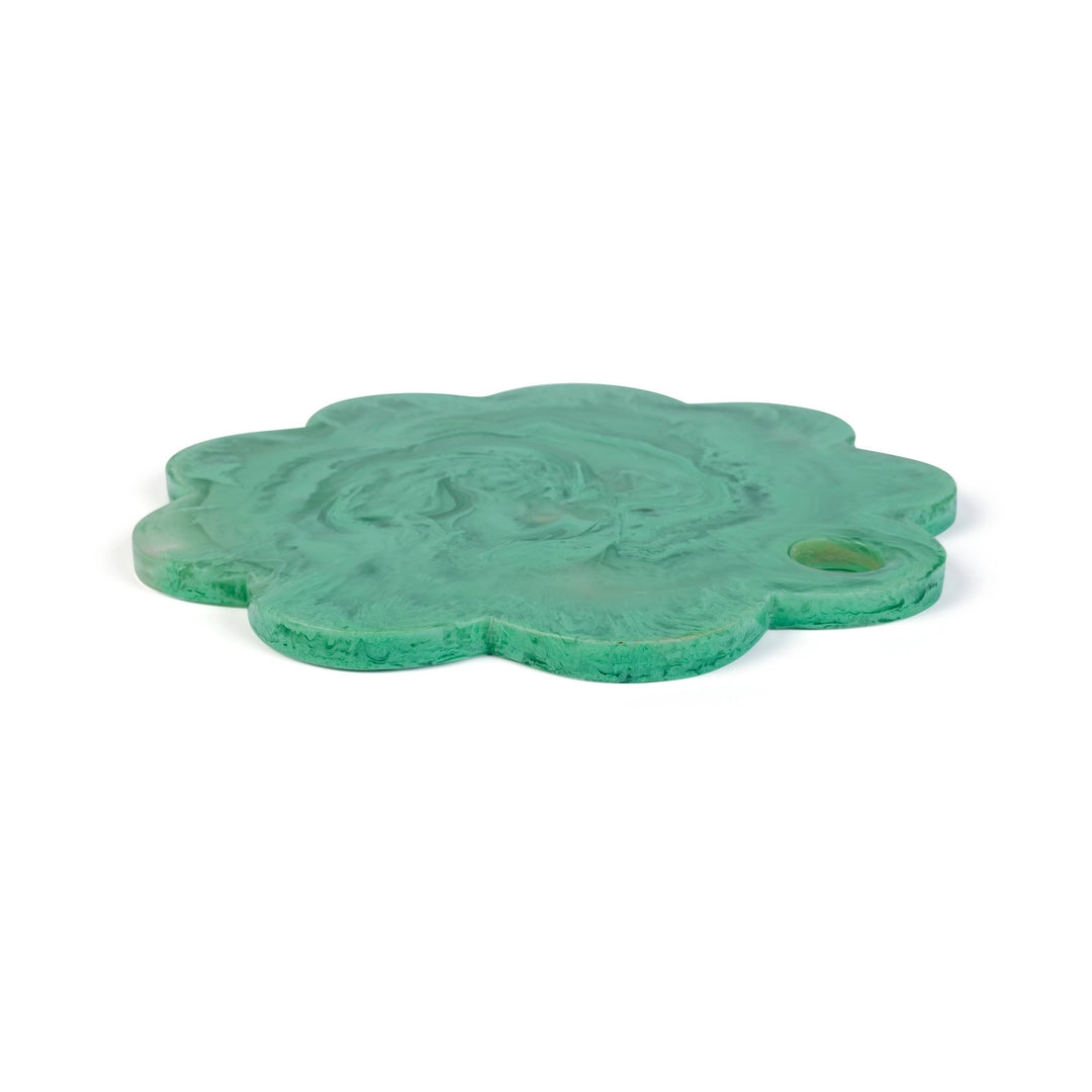 A green, flower-shaped carved stone plaque featuring a central relief of a winged figure and a small circular hole on the right side, shown on a plain white background.