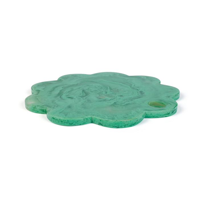 A green, flower-shaped carved stone plaque featuring a central relief of a winged figure and a small circular hole on the right side, shown on a plain white background.