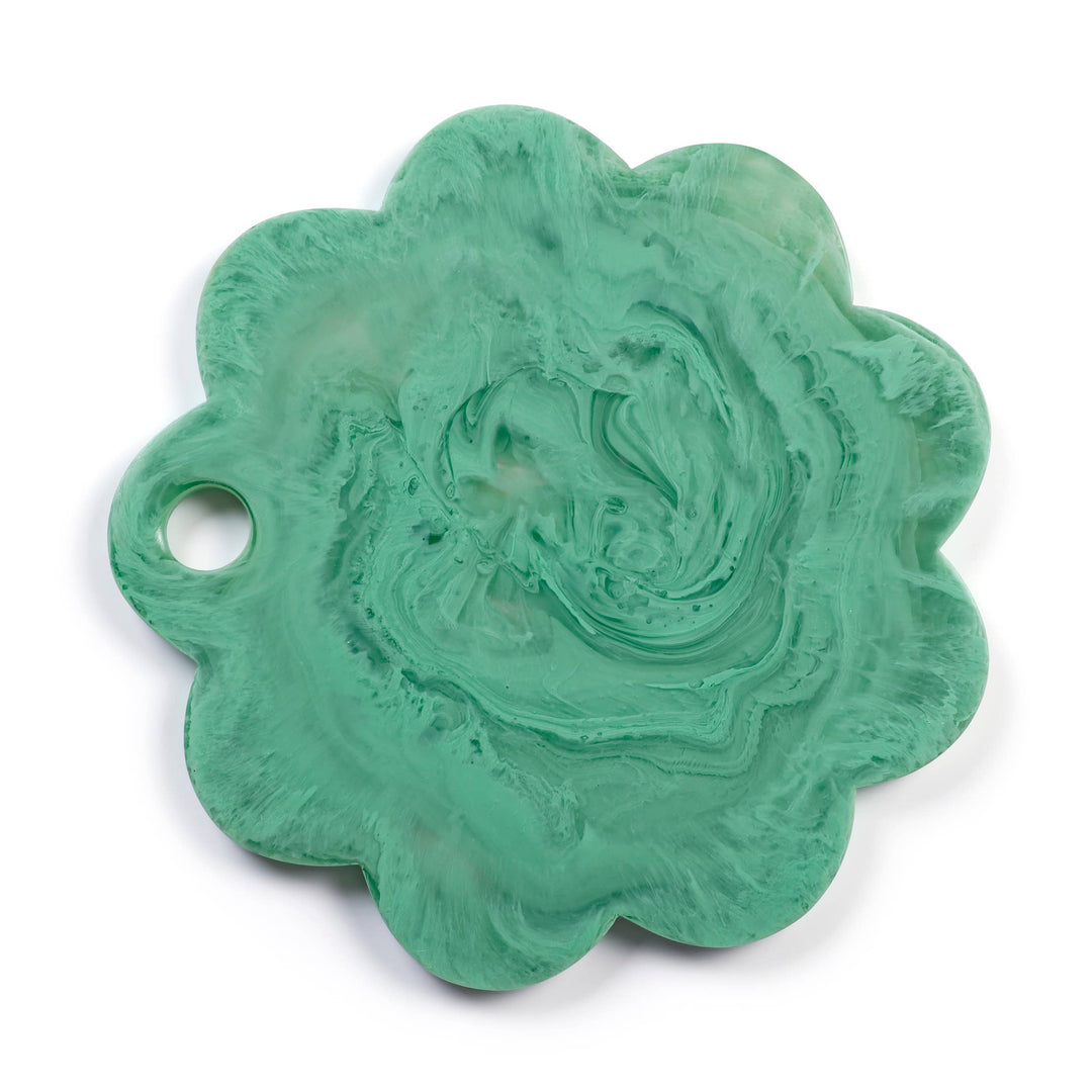 A scalloped, flower-shaped resin charm with a hole on one side, featuring a swirled mint green and white marbled pattern, shown on a white background.