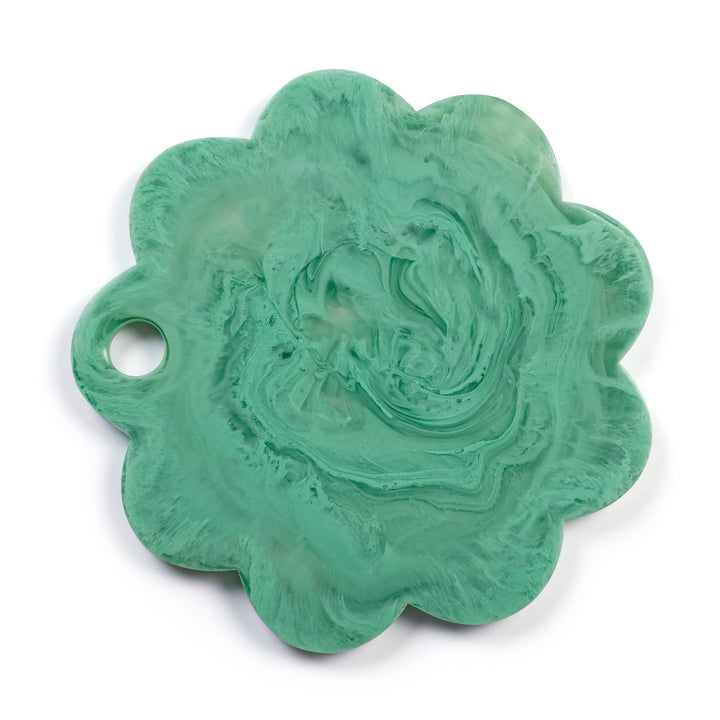 A scalloped, flower-shaped resin charm with a hole on one side, featuring a swirled mint green and white marbled pattern, shown on a white background.