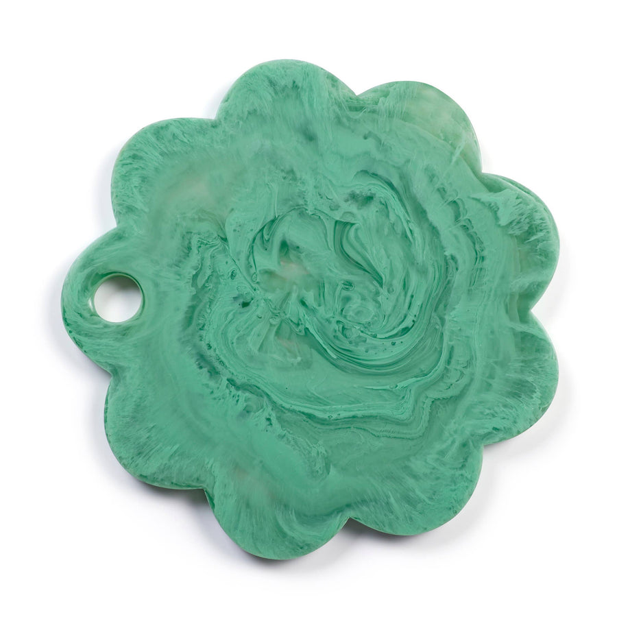 A scalloped, flower-shaped resin charm with a hole on one side, featuring a swirled mint green and white marbled pattern, shown on a white background.