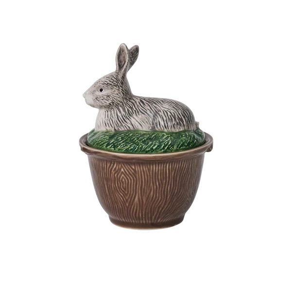 A bowl with a ceramic rabbit lid  on a white background
