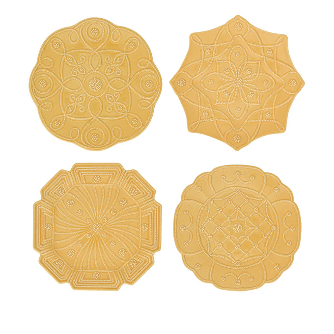 Four yellow plates of different shapes with decorative patterns 
