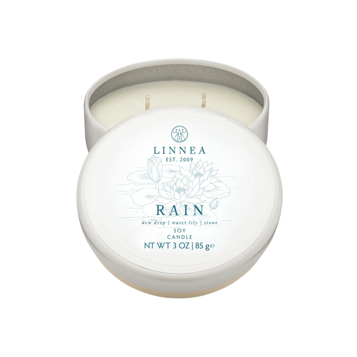 A Linnea Rain scented candle travel tin