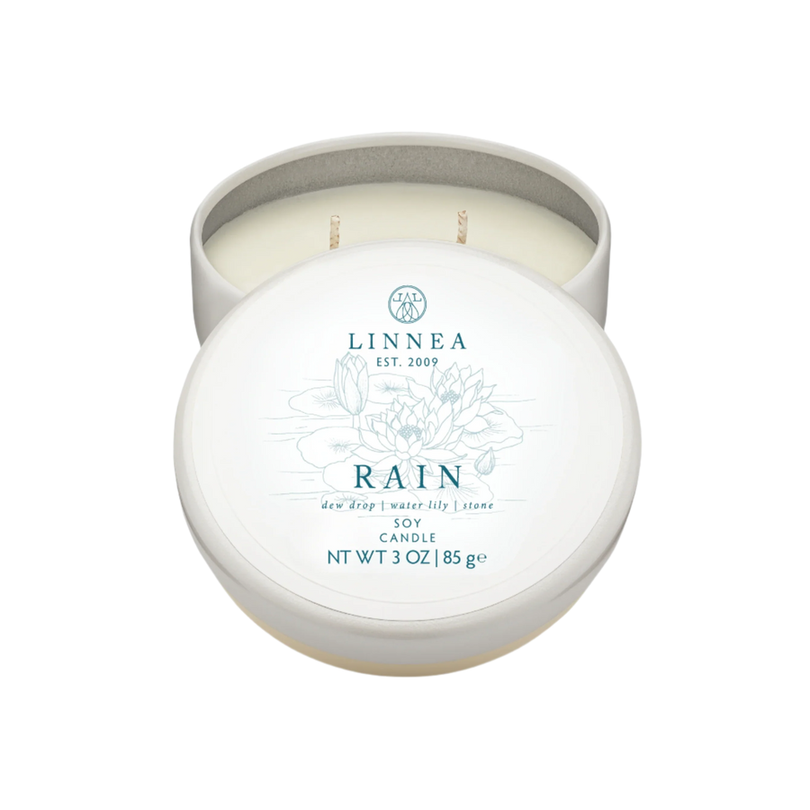 A Linnea Rain scented candle travel tin