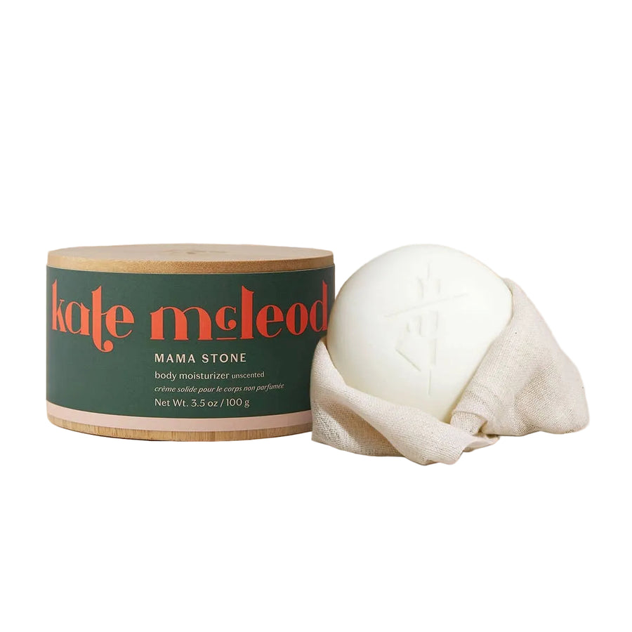 A lotion bar sitting in a canvas towel  next to its bamboo anti-climate change packaging because this is an ecological brand.