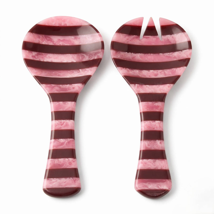 A set of two pink and dark red striped serving utensils, likely a spoon and a small spatula or server, shown on a plain white background.
