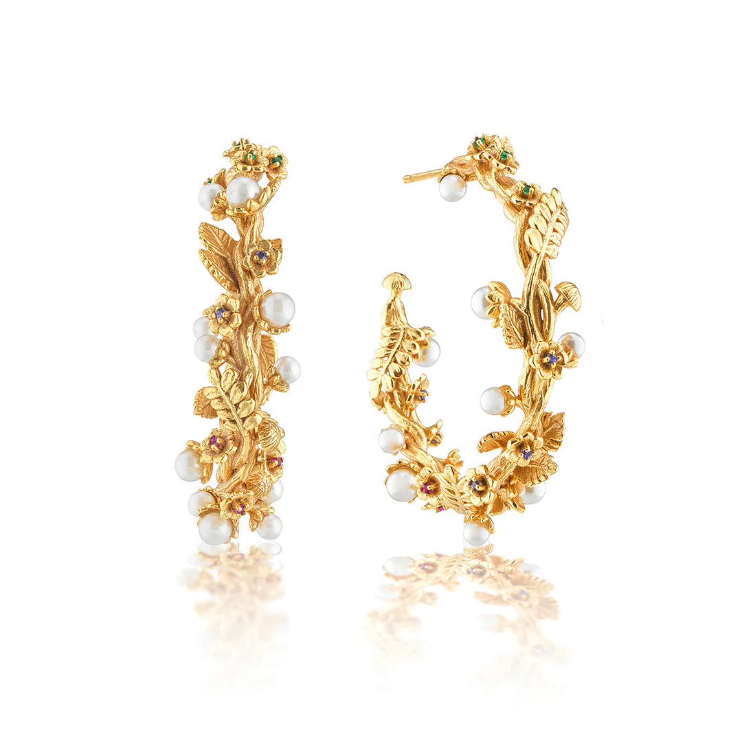 A set of elaborate floral hoop earings with pearls