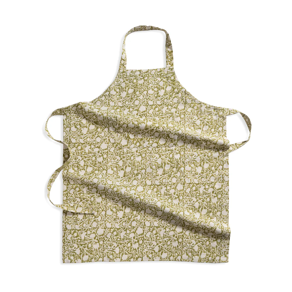 Floral patterned green and white apron on a white background