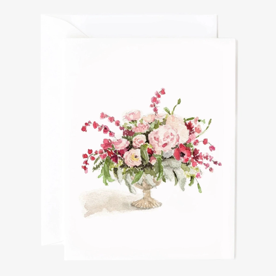 Watercolor loral arrangement in a vase painted onto a card sitting on top of an envelope