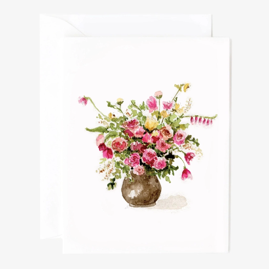 Floral arrangement watercolor in a vase painted on a white card sitting on an envelope