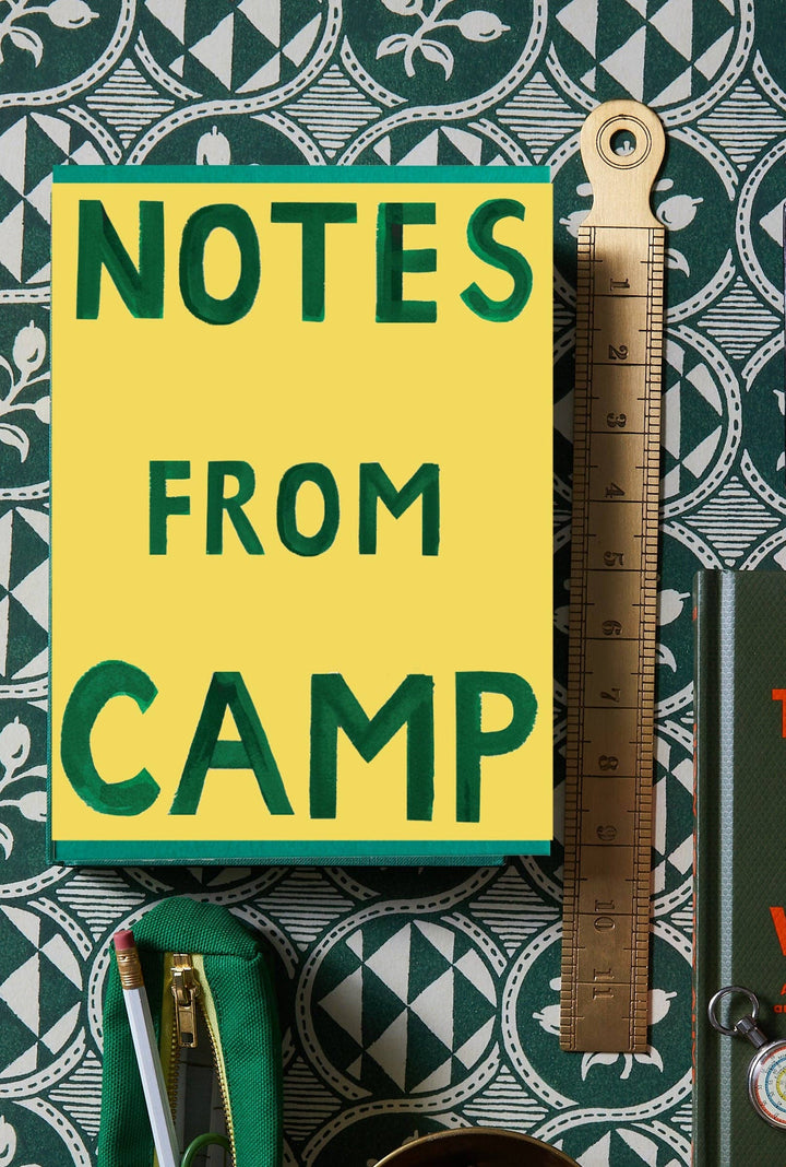 Notebook box of greeting cards titled 'Notes from Camp' with a ruler on a patterned background