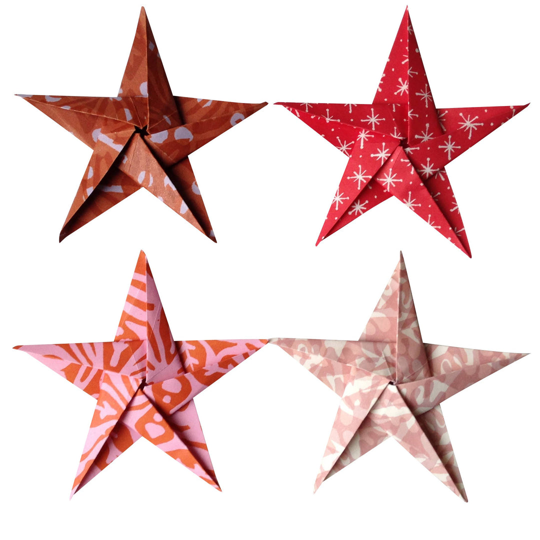 Four patterned red and pink paper stars on a white background