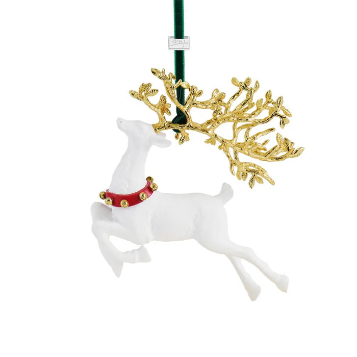 Decorative white porcelain reindeer ornament with gold antlers and red collar on a white background