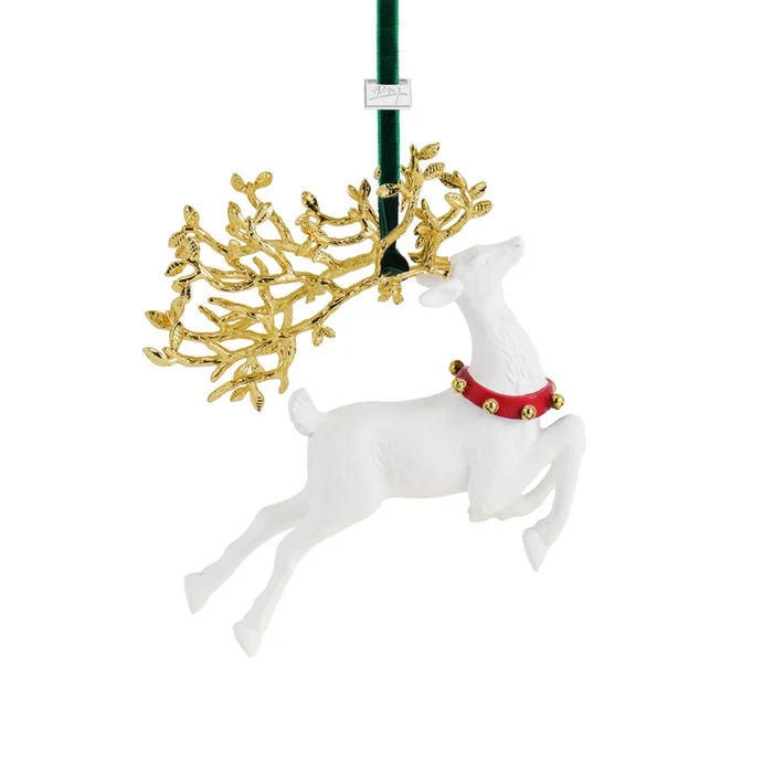 Decorative white porcelain reindeer ornament with gold antlers and red collar on a white background