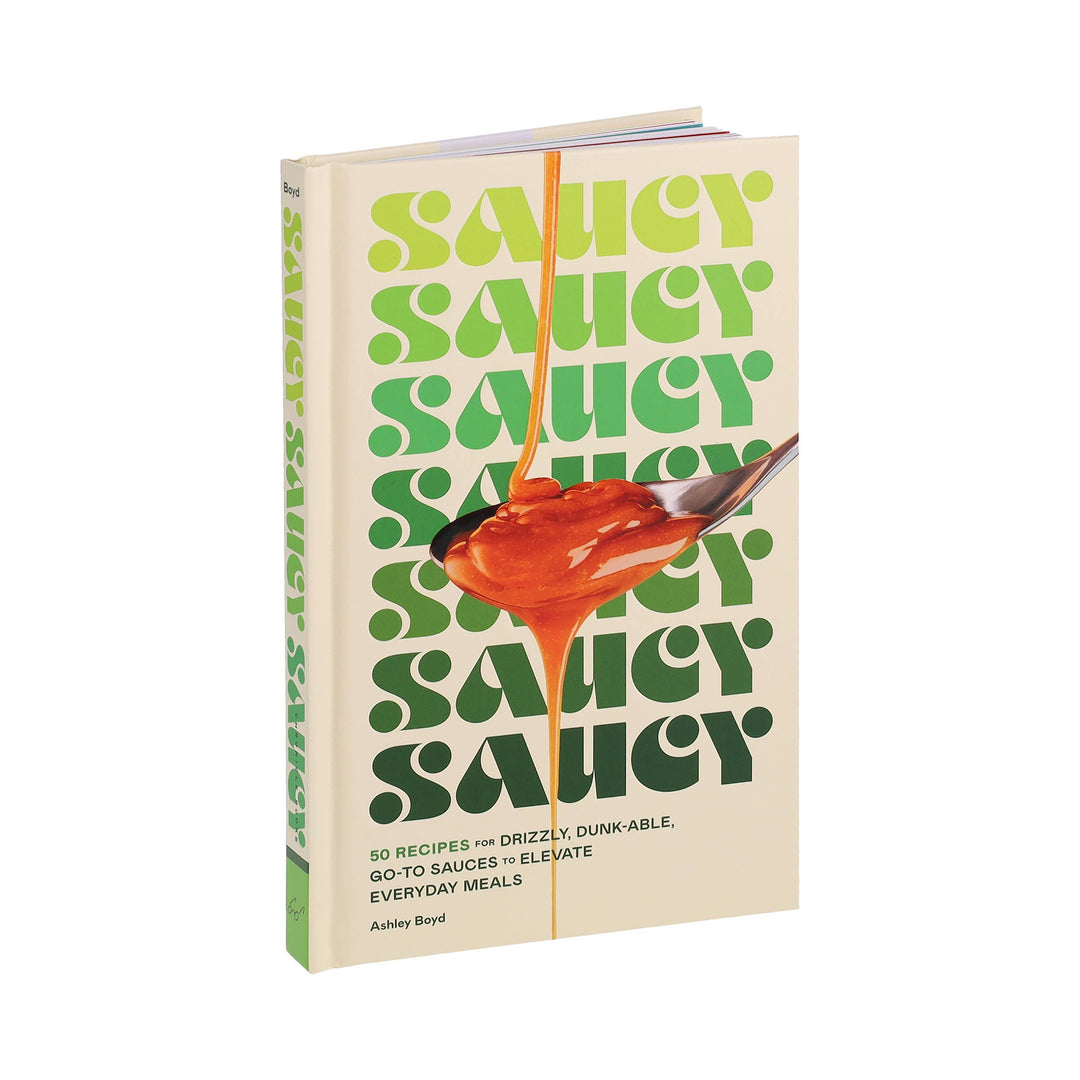 Book titled 'Saucy' with a spoon dripping sauce on a white background