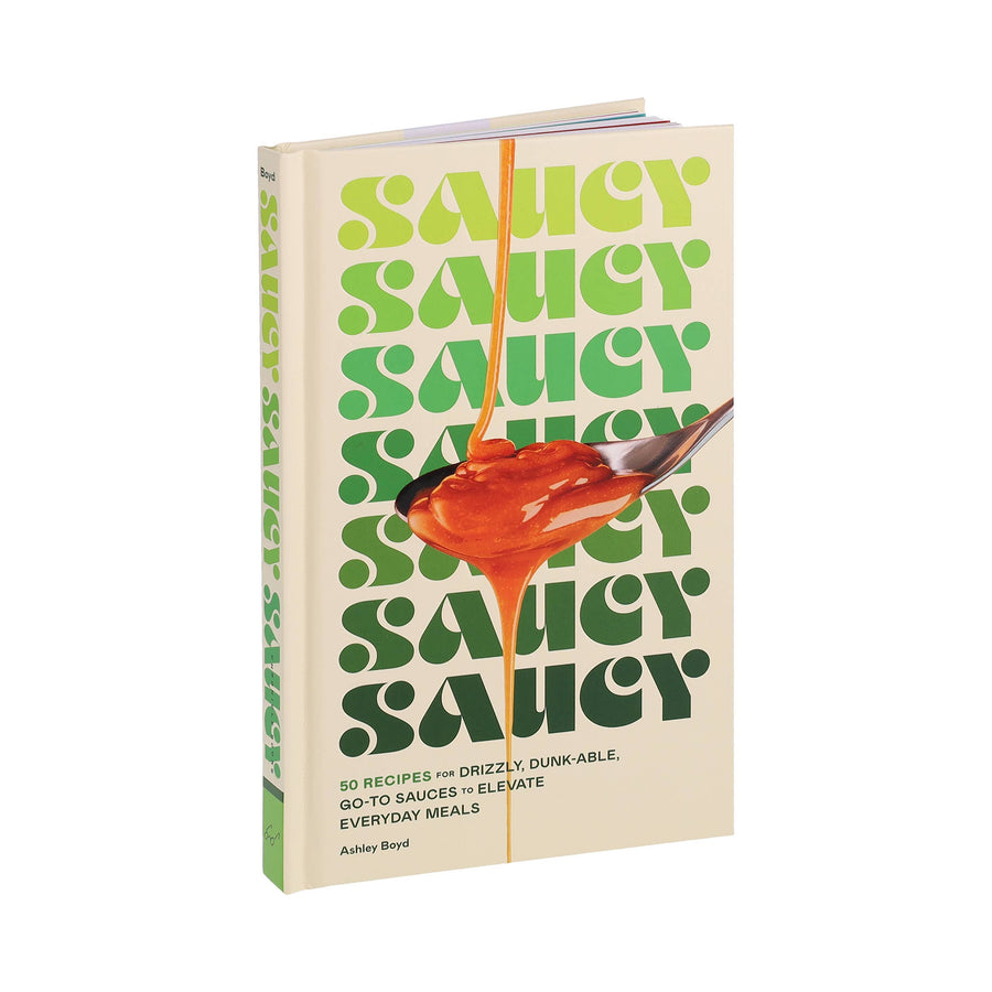 Book titled 'Saucy' with a spoon dripping sauce on a white background