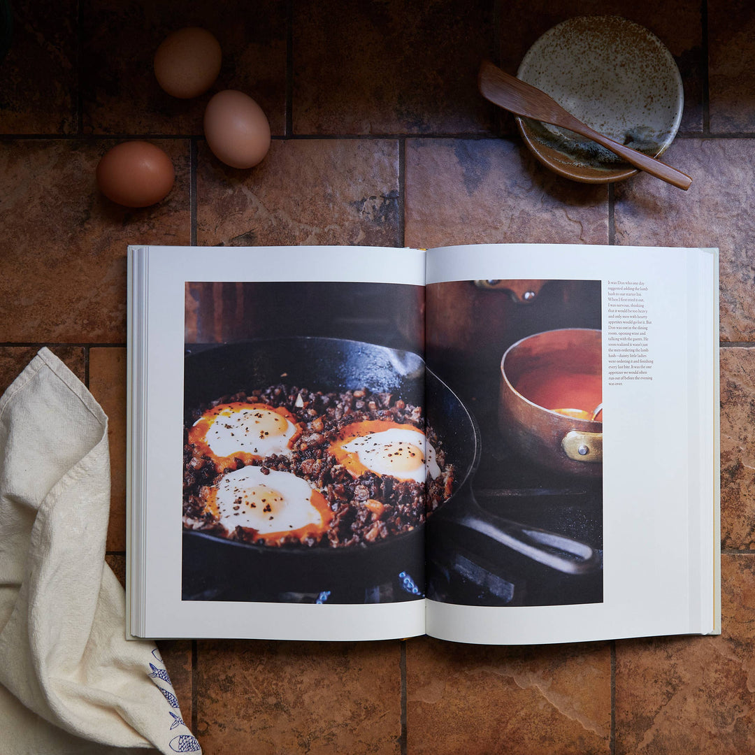 Open cookbook showing a recipe with eggs on a wooden surface