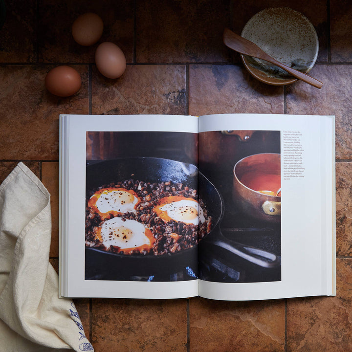 Open cookbook showing a recipe with eggs on a wooden surface