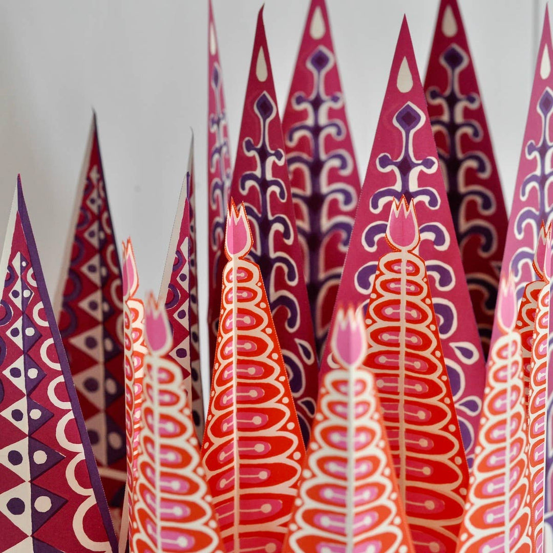 colorful red, purple, and pink paper party crowns
