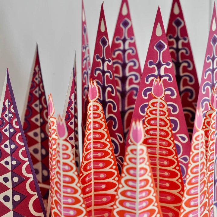 colorful red, purple, and pink paper party crowns