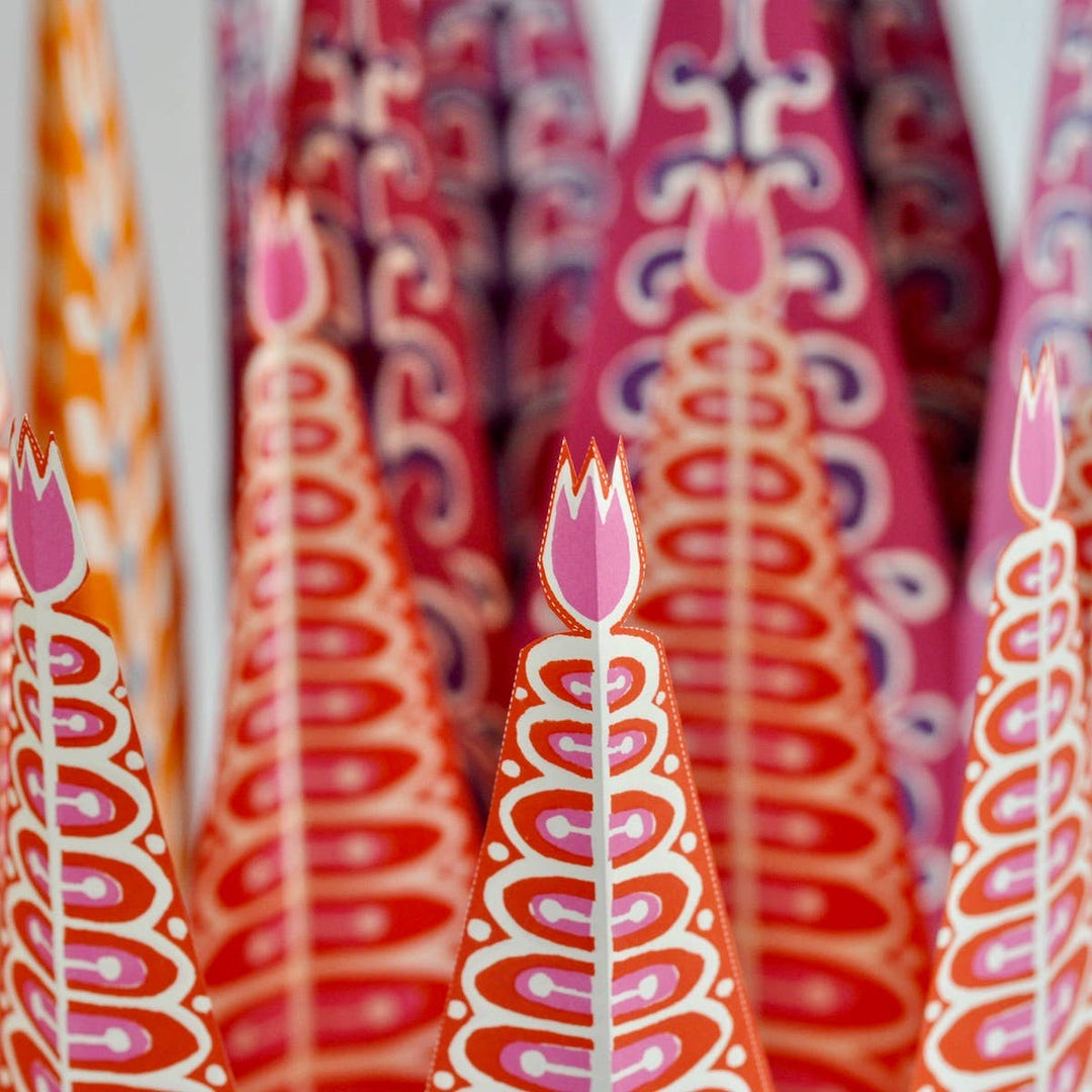 Decorative paper straws with floral design in red, orange, and pink.