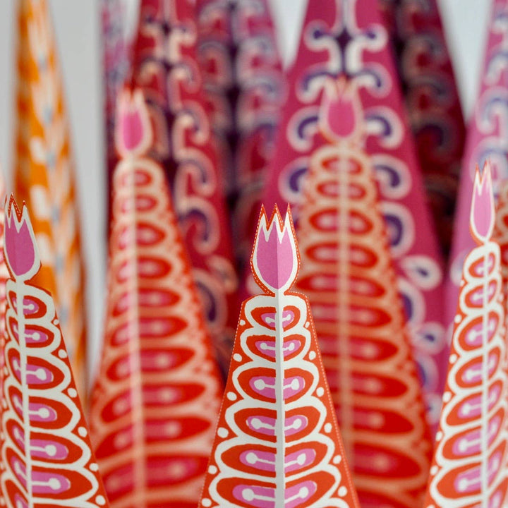 Decorative paper straws with floral design in red, orange, and pink.