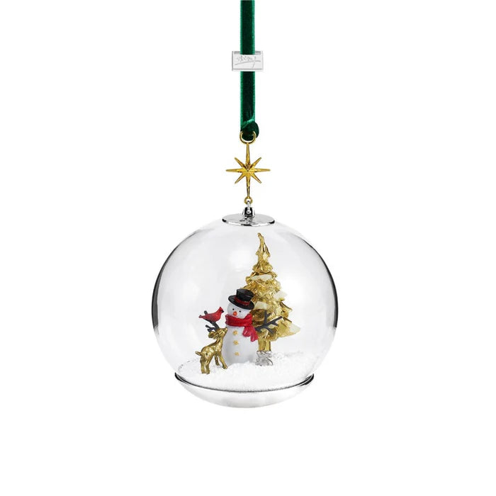 A christmas ornament styled like a snowglobe with a snowman and a gold christmas tree