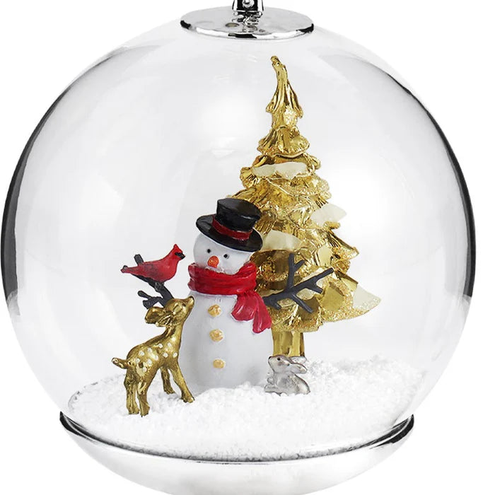 Christmas ornament with snowman, gold tree, and cardinal in a snowglobe