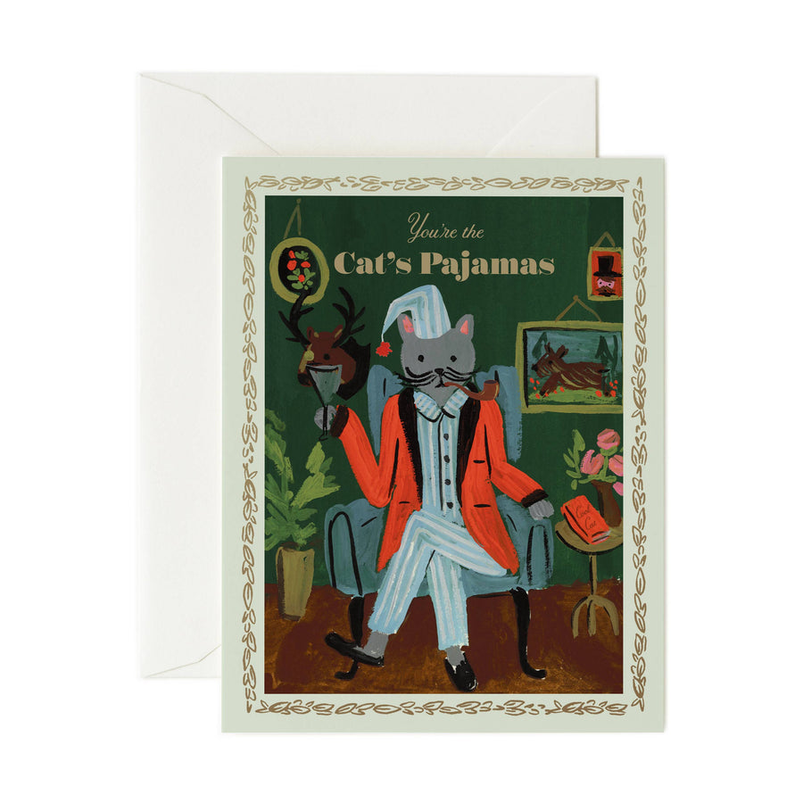Greeting card with illustration of a cat in human clothing and text 'You're the Cat's Pajamas' on a green background with gold trim artwork.