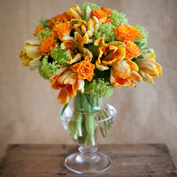 designers choice arrangement bouquet green hydragneas orange and yellow tulips orange roses