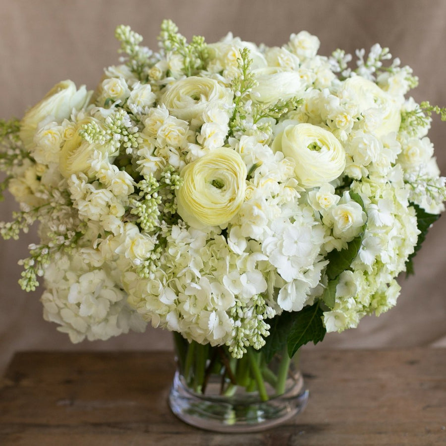 sympathy floral arrangement white ranunculus white roses hydrangea flowers