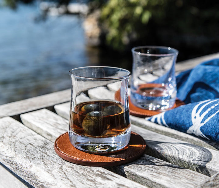 Simon Pearce Shoreham Whiskey glasses on coaster with stones